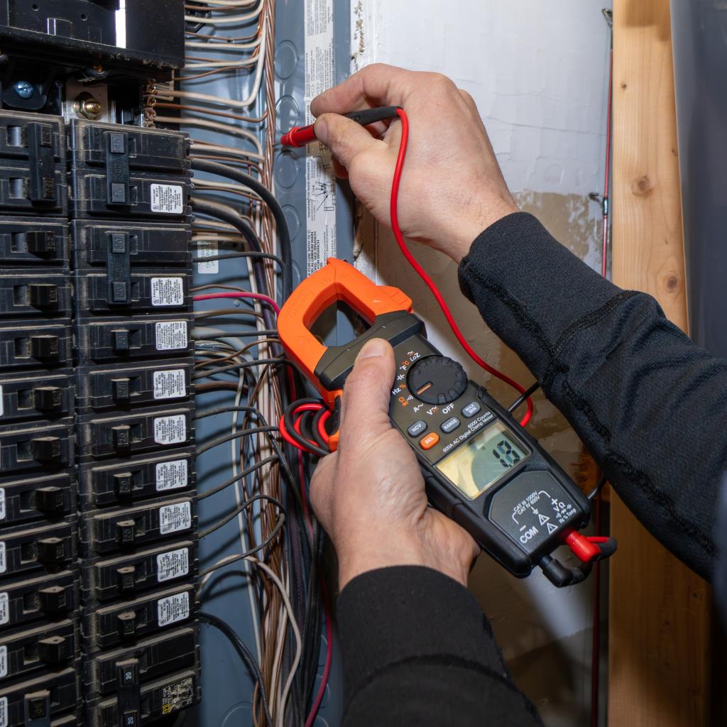 Home inspector testing a home's electrical panel for safety hazards